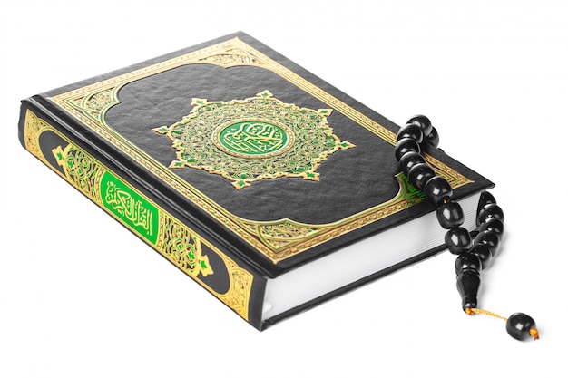 Islamic Book Holy Quran and beads on withe background