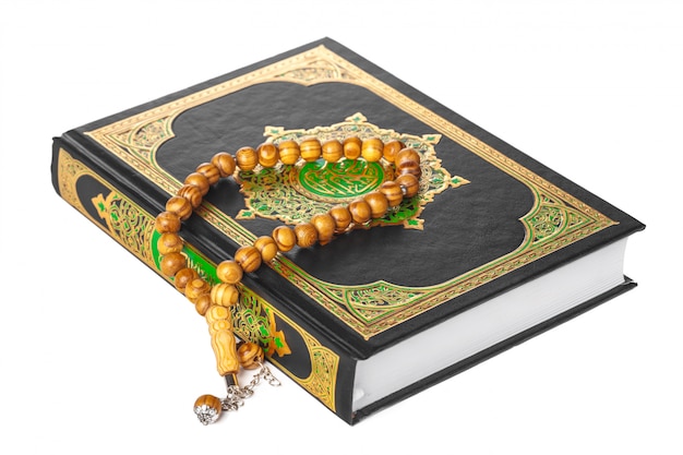 Islamic Book Holy Quran and beads on withe background