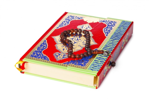 Islamic Book Holy Quran and beads on withe background