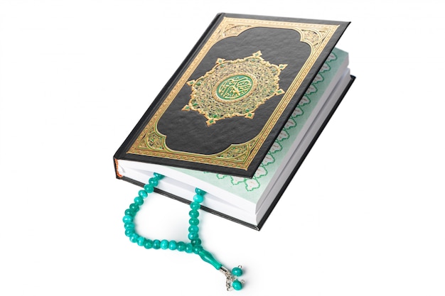 Islamic Book Holy Quran and beads on withe background