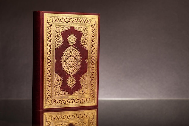 Islamic Holy Book Quran Under Soft Light on Black Background