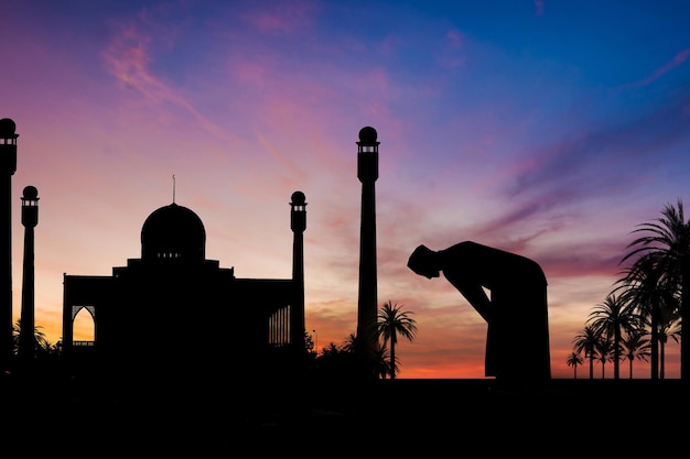 Islamic man praying Muslim Prayer in Twilight time