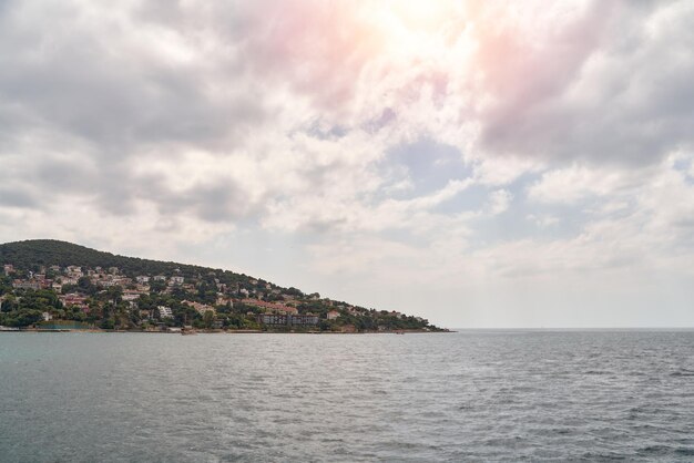 Island shoreline with buildings and trees view from water