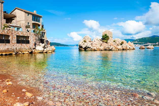 Island with old castle on the beach in Przno near Budva, Montenegro. Adriatic sea. Famous travel destination