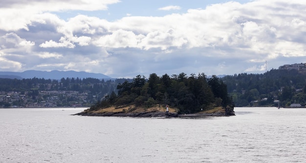 Islands with trees and lighthouse surrounded by homes on a cloudy day