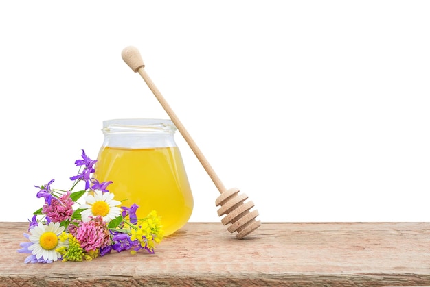 isolate of fresh bee honey on a wooden plank a bouquet of wild flowers