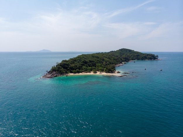 Isolated beautiful tropical island with white sand beach and blue clear water and granite stones. Top view, speedboats above coral reef. Similan Islands, Thailand