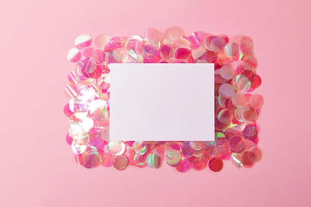 Photo isolated blank card lies on top of the shiny holographic confetti