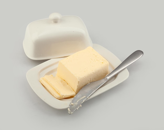 Isolated butter dish with butter and table knife