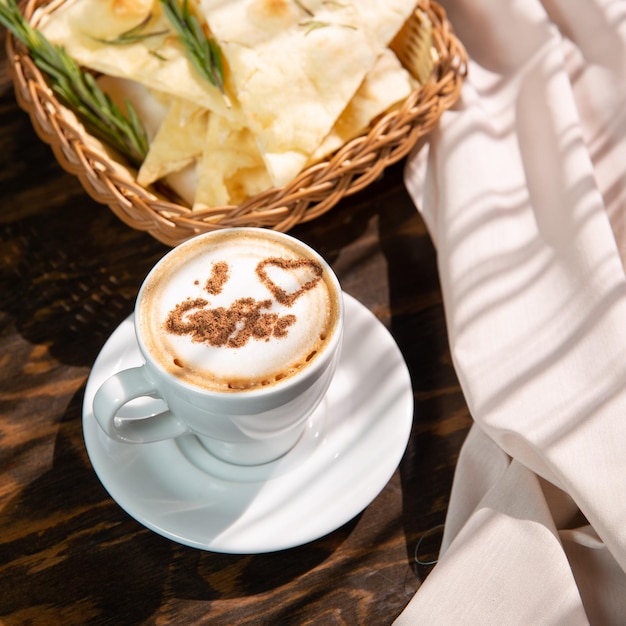 isolated cappuccino with decorated topping in a white cup on red background copy space