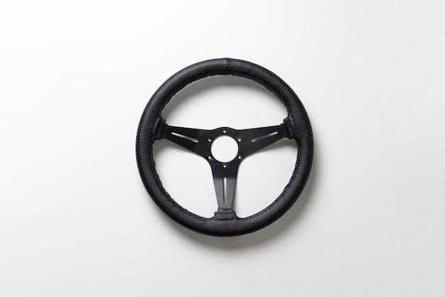 The isolated car steering wheel on the flat surface simple transportation concept