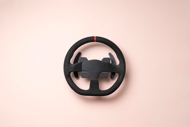 The isolated car steering wheel on the flat surface simple transportation concept