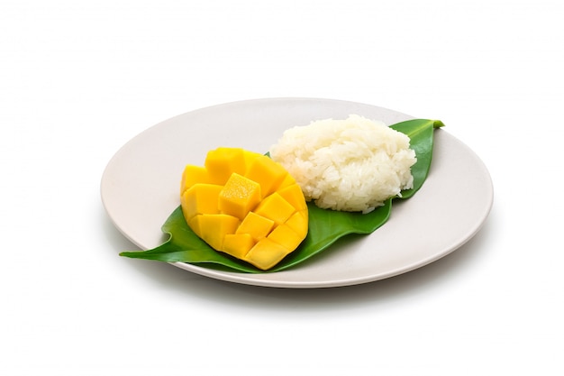 Isolated dish of carve beautiful yellow mango with sticky rice on white