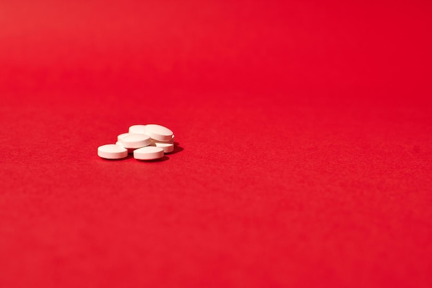 Isolated pills on a red background