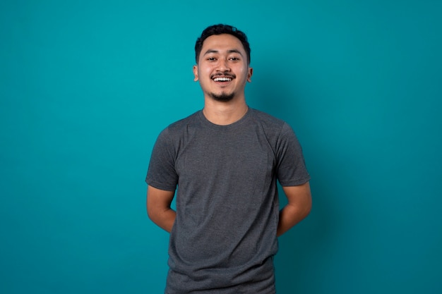 Isolated shot of young handsome male with beard on blue background