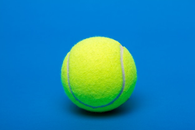 Isolated tennis ball over a blue background.