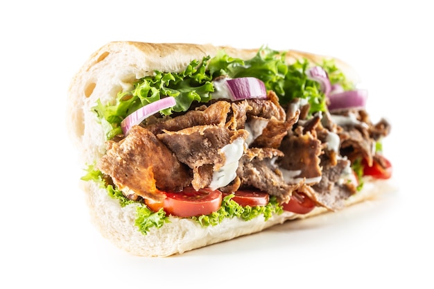 Isolated Turkish kebab baguette with generous portion of vegetables and properly grilled veal or chicken meat.