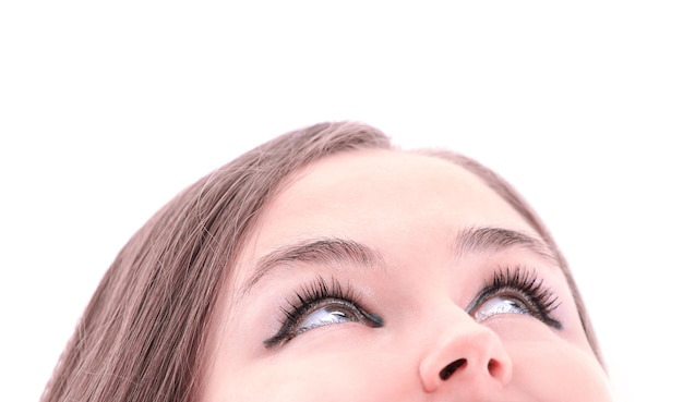 Isolated young woman looking upwards isolated on white background