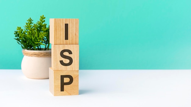 Isp word from wooden blocks with letters green background copy space available