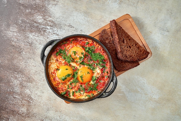 Israeli scrambled eggs shakshuka with tomatoes and onions. Close-up, selective focus