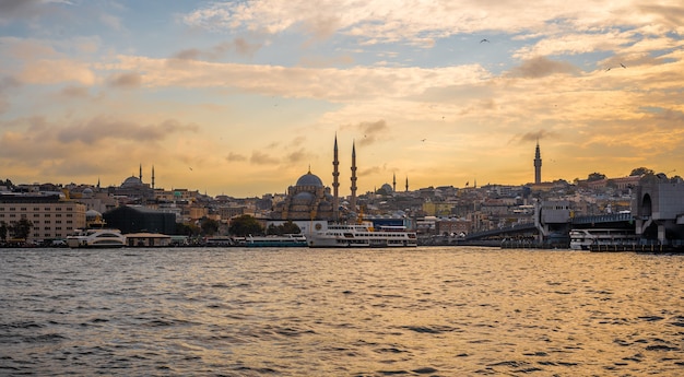 ISTANBUL, TURKEY - October 26, 2021: Istanbul at sunset from Galata bridge. View of the Suleymaniye Mosque. Best touristic destination of Istanbul