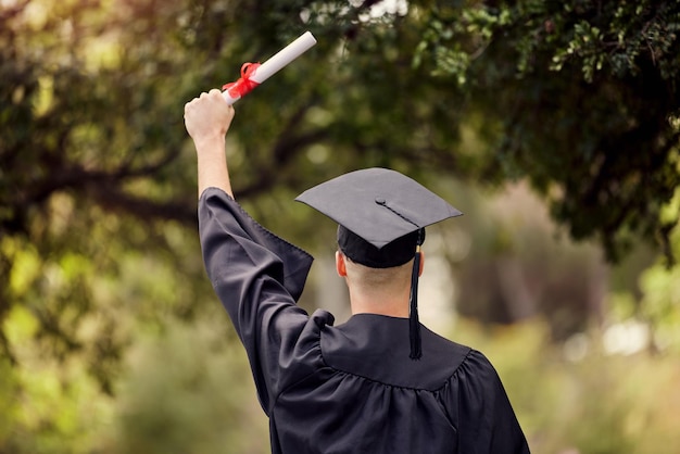 It can only get better from here on. Rearview shot of a young man cheering on graduation day.