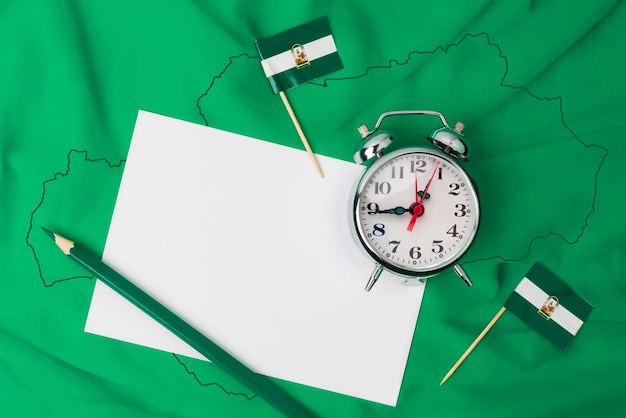 It is the time of Andalusia community of southern Spain Flag background with a note pencil and clock