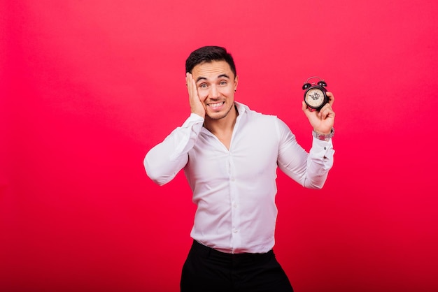 It is your time portrait of young man in showing time on clock watch ok thumb up approve