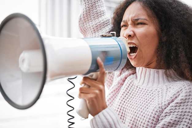 It took me a long time to develop a voice Shot of a young woman screaming into a loud speaker while protesting in the city