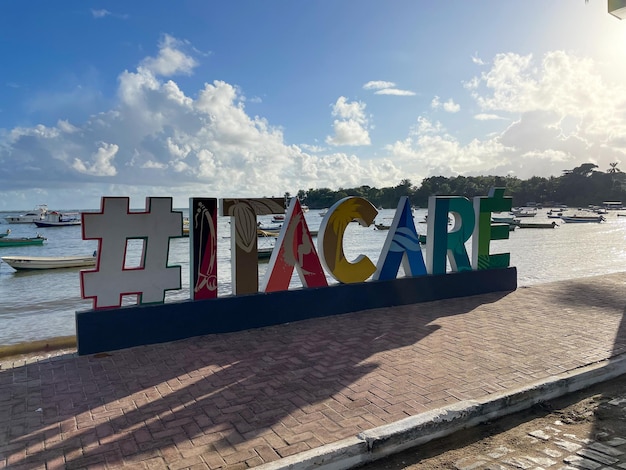 Itacare Bahia Bazil 02 2023 Itacare beach Bahia Brazil Village with fishing boats and tourist sign with the writing of Itacare