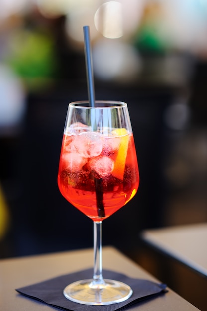 Italian aperitives/aperitif: glass of cocktail (sparkling wine with Aperol) and appetizer platter on the table