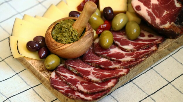 Italian board Cheese olives prosciutto pesto