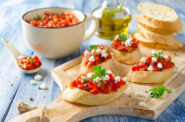 Italian bruschetta with chopped tomatoes and cheese on grilled crusty bread