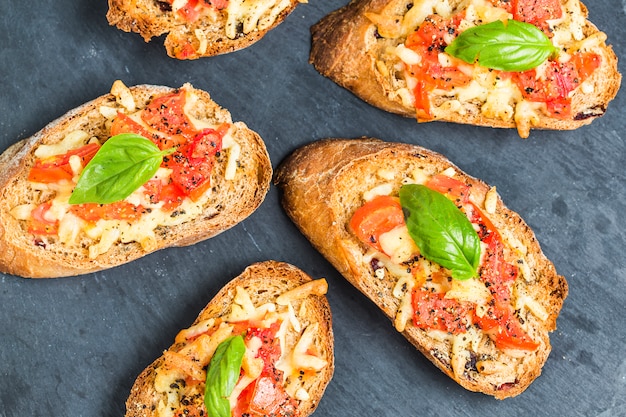 Italian bruschetta with roasted tomatoes, mozzarella cheese and