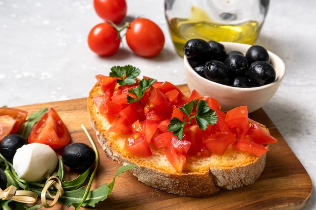 Italian bruschetta with tomatoes, olive oil, green parsley. typical Italian antipasti starter in restaurant in Italy Rome Milan.