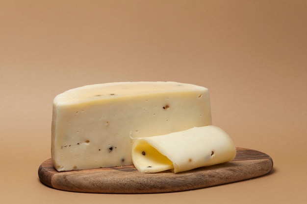 Italian Caciotta cheese with black peppercorns