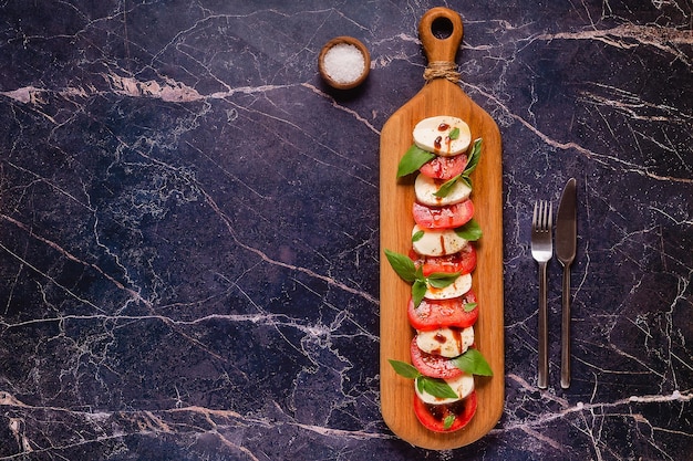 Italian caprese salad with sliced tomatoes mozzarella basil olive oil