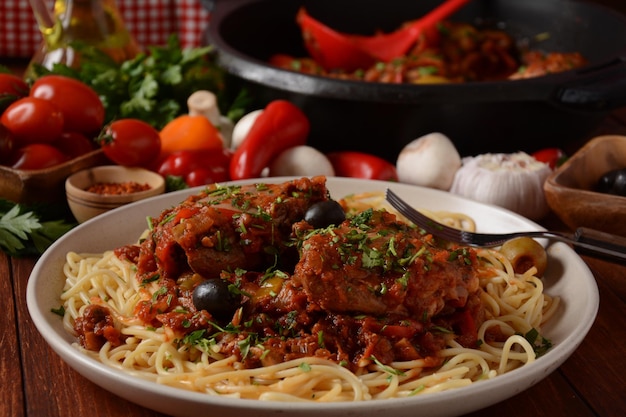 Italian chicken Cacciatore hunter's stew with spaghetti noodles