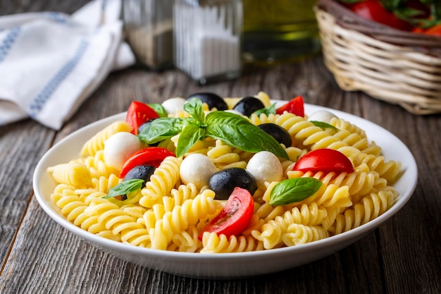 Italian cold pasta salad or Pasta fredda alla caprese. Directly above. Fusilli, tomato, mozzarella, olive, arugula. Turkish name; burgu makarna salatasi