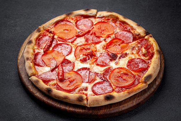 Italian Cuisine Pepperoni pizza with salami sausage and red hot pepper