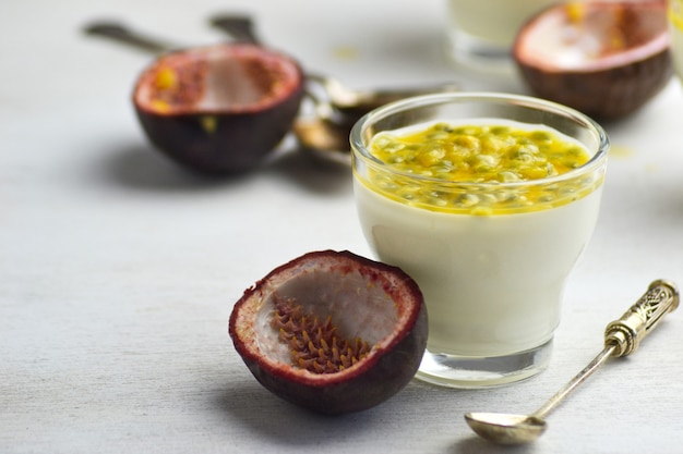 Italian dessert panna cotta with fresh passion fruits on white background