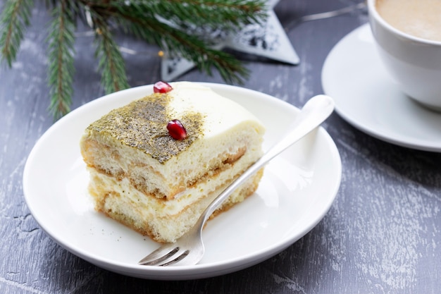 Italian dessert tiramisu, made with matcha tea and limoncello, decorated for Christmas or New Year. Selective focus.