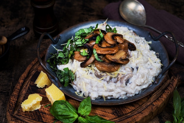 Italian dish risotto with mushrooms, Parmesan and herbs.