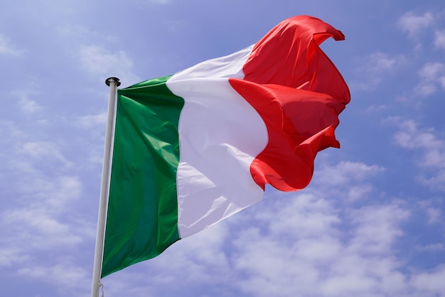 Italian flag on mat in the wind and blue sky cloud