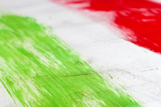  Italian flag painted with  brush strokes on white background.