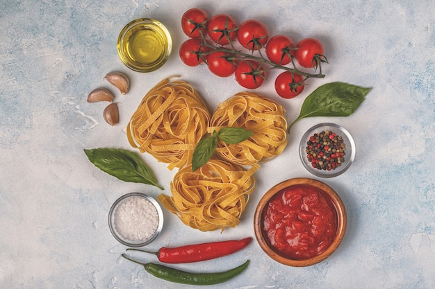 Italian food background with pasta, spices and vegetables