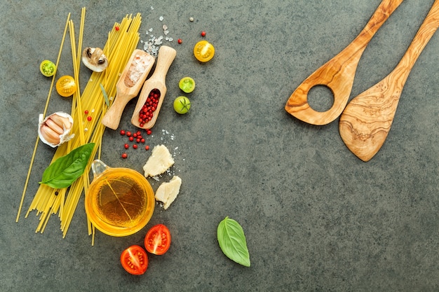 Italian foods concept and menu design. Pasta with ingredients on stone background .