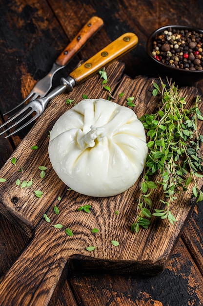 Photo italian fresh cheese burrata on a wooden cutting board