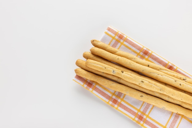 Italian Grissini Breadsticks with olive pieces on white background Dry baked bread