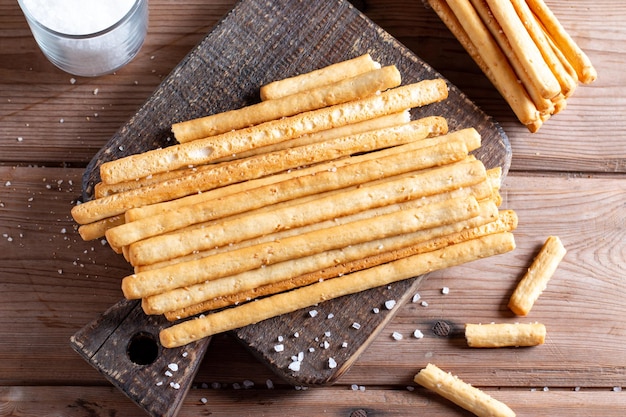 Italian grissini or salted bread sticks tied with rope on table Top view